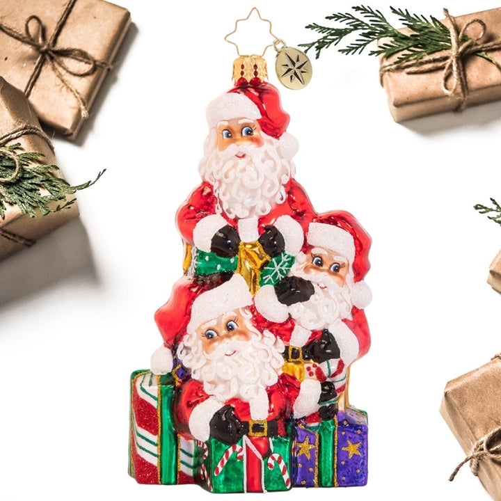 Ornament Description - A Tremendous Trio of Santas: Good things come in threes! It is not easy to get all the way around the world in a single night, so Santa used a little Christmas magic to clone himself a few extra pairs of hands this year.