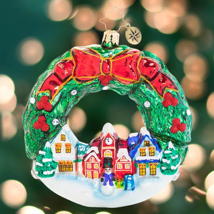 Ornament Description - An All-Around Christmas Town!: Frosty's festive holiday village is ready for the most magical time of year, glowing under a traditional fresh holly swag. The villagers cannot wait to hear the first carolers of the season!
