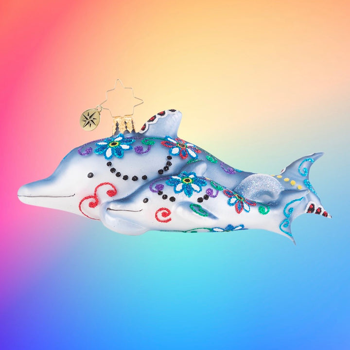 Ornament Description - Swimming Through Florals: This pair of playful dolphins has been gussied up in their finest festive florals of the season. Now they are off to play in the waves!