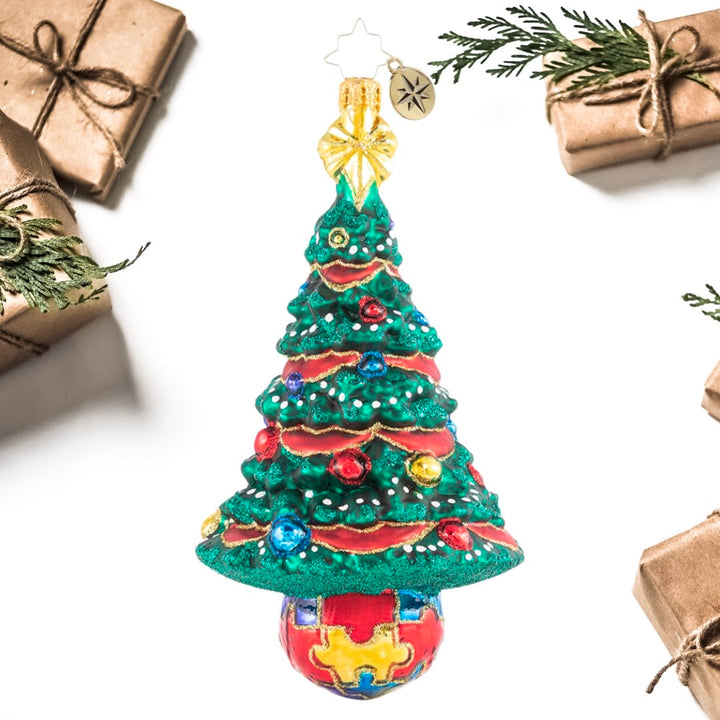Ornament Description - Puzzle Pieces Pine: Featuring the trademark autism puzzle piece symbol, this beautiful tree is unique and bright just like the special children it represents! A percentage of the sales from this ornament will benefit a charity that raises Autism awareness.