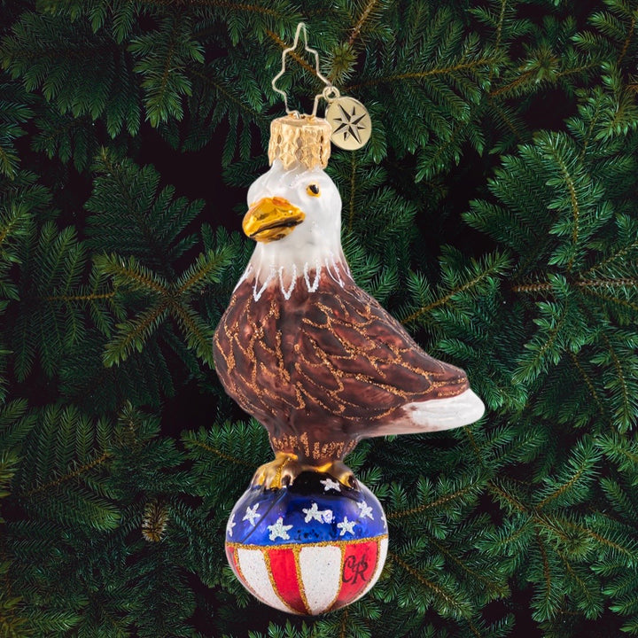Ornament Description - Stars & Stripes Bald Eagle Gem: Over purple mountains' majesty and above the fruited plainâ€¦there's no question that this little feathered fella is proud to be an American, in the land of the free and the home of the brave!