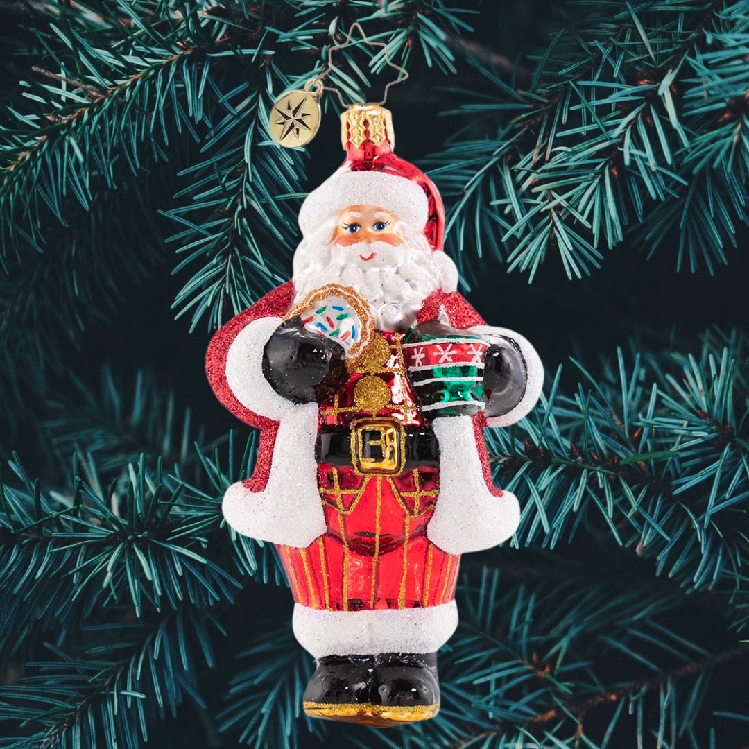 Ornament Description - Cocoa Cravings Claus: There is nothing quite like a creamy cup of hot cocoa to warm up after a snowy night's work at the North Pole. Santa knows it always tastes better out of his favorite holiday cup and with one of Mrs. Claus's freshly baked sugar cookies on the side!