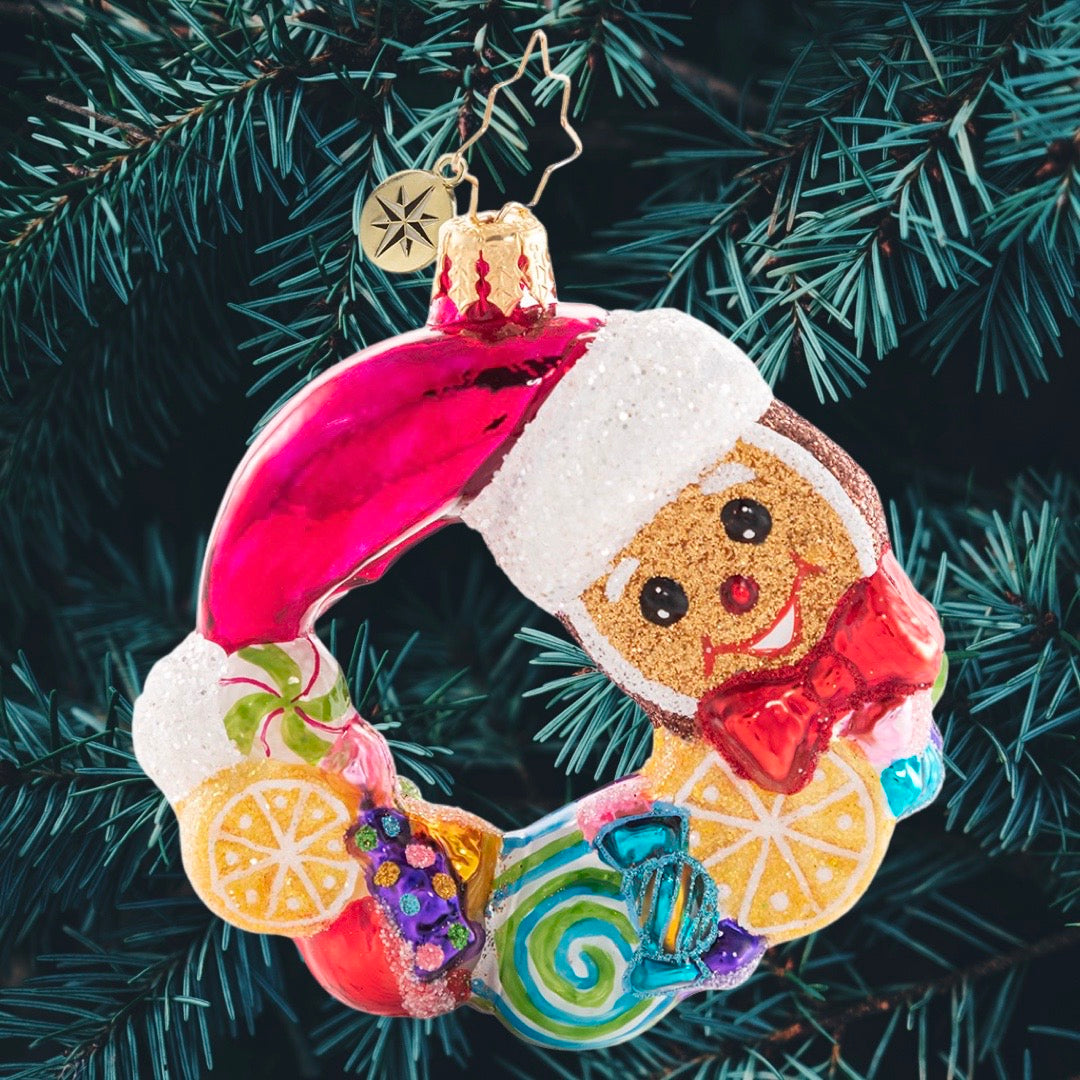 Ornament Description - Swirling With Sweets Wreath Gem: Forget visions of sugarplumsâ€¦between all these swirling lemons, peppermints, and other treats this little gingerbread man is sure to have some very sweet dreams!