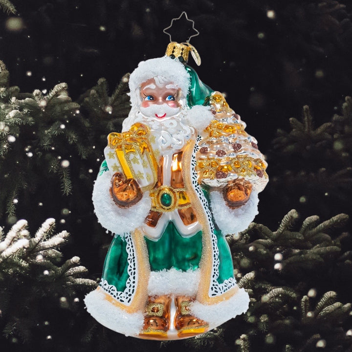 Ornament Description - Emerald City Santa: Santa has ditched his traditional ruby red robes for a different look – elegant emerald green and gold! He shows off his glitzy offerings on the way to a North Pole Christmas party.