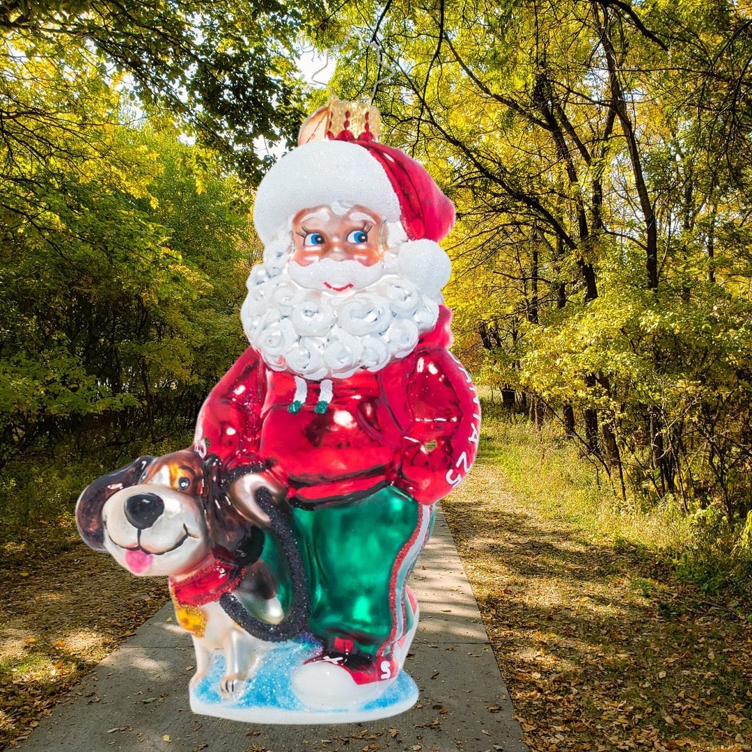 Ornament Description - Santa's Best Friend: Just call him Santa Paws! Old Saint Nick shows his soft spot for four-legged friends on a walk with his canine companion.