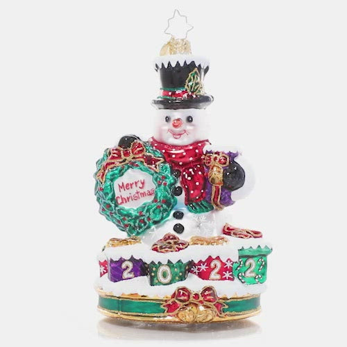 Ornaments - Description: Celebrate 2022 with a smile, just like the one on this happy snowman's face. Surrounded by gifts ready to give, he's really feeling the spirit of the season!