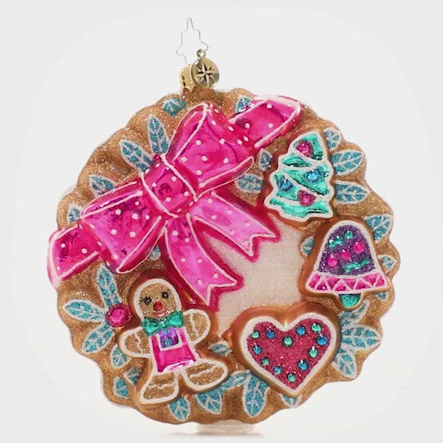 Video - Ornament Description - Sweet Treats Wreath: A smiling gingerbread man and other holiday shapes shine from their place on this festive iced cookie wreath. What could be sweeter? This video shows the ornament spinning slowly. 