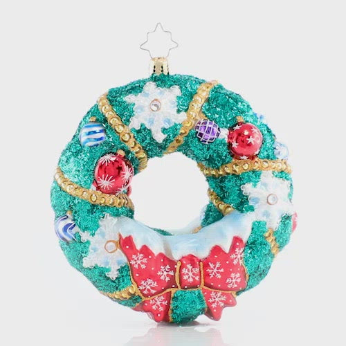 Video - Ornament Description - Flurry of Flakes: A surprise flurry has passed through town, frosting everything in sight! This dazzling holiday wreath stands out despite all the snow! This video shows the ornament slowly spinning.