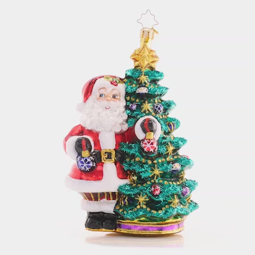 Video - Ornament Description - Deck the Halls Santa: Santa is ready to show off his extensive ornament collection as he trims his Christmas tree with beautiful glass baubles.
