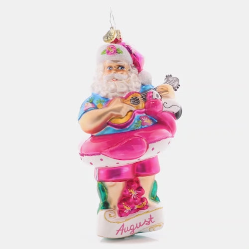 Video - Front - Ornament Description - Beating the Heat: Santa is soaking up some summer sun, giving his ukulele a sound strum. As the eighth piece in our Ornament of the Month collection, he is here to savor summer.