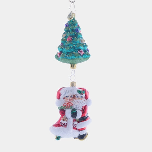 Video - Ornament Description - Meet Me Under the Tree: Mr. and Mrs. Claus sure do make a magnificent couple! These Christmas cuties dance together under a trimmed tree. Where's the mistletoe? This video shows the ornament spinning slowly. 