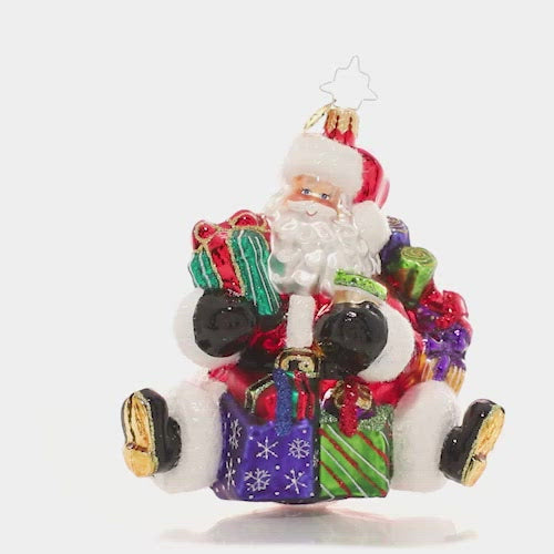 Video - Ornament Description - That's a Wrap Santa!: No surprise that the Christmas king is also a major wrap star! Santa's ready to give with his arms loaded with lovingly-wrapped presents in every size and shape. This video shows the ornament spinning slowly. 