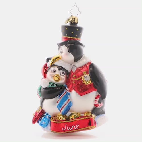 Video - Ornament Description - Here's to the Dads: This dapper dad penguin gives his kiddo a playful peck as they celebrate a fun Father's Day. The sixth piece in our Ornament of the Month collection celebrates dad! This video shows the ornament spinning slowly.