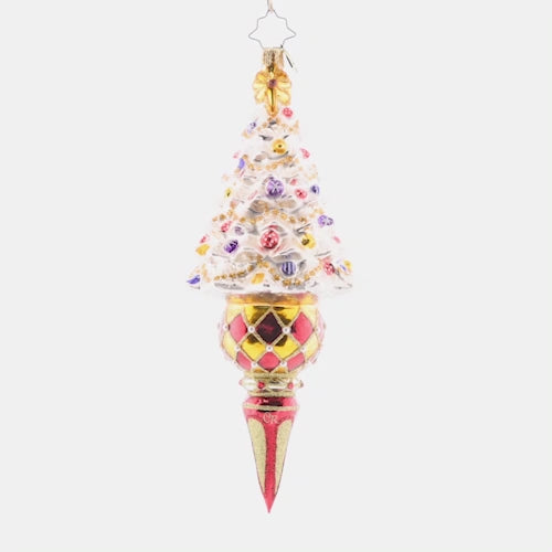 Video - Ornament Description - Winter Elegance Tree: This tastefully-trimmed snow white tree glitters with gems and tinsel atop an elegant drop-shaped base. Add elegance and flair to your collection with this standout piece. This video shows the ornament spinning slowly. 