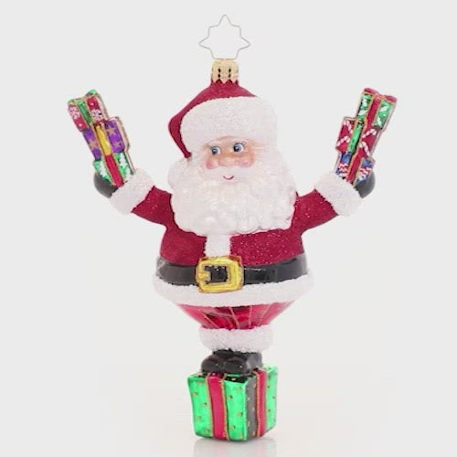 Video - Ornament Description - Top Of His Game Claus: Ta-dah! Santa shows off quite the balancing act--perched atop a green gift box, he surprises us with even more tiny treasures. Wonder what else he has got up his sleeve! This video shows the ornament spinning slowly. 