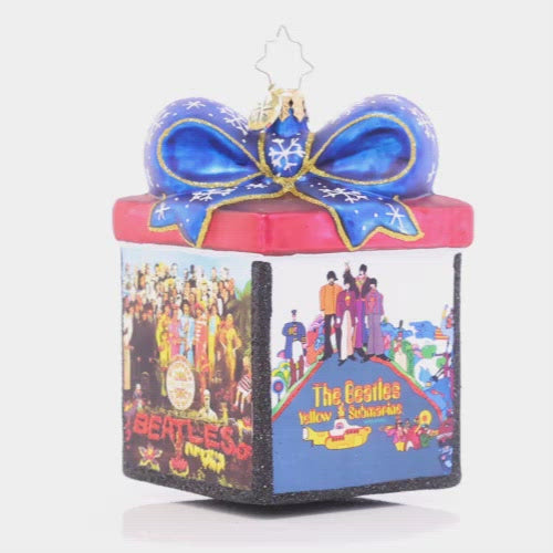 Video - Ornament Description - The Gift of The Beatles: Now this is our kind of music box! Featuring the cover art for four of the Beatles' later albums, this dazzling gift box ornament is the ideal addition to any fan's collection. This video shows the ornament spinning slowly. 