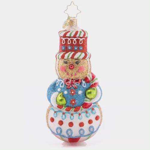 Video - Ornament Description - Sweetest Snowman: With his sugary smile and sweet frosting swirls, this gingerbread snowman is the cutest Christmas cookie in the batch! Decorate your tree with this darling piece this season. This video shows the ornament spinning slowly. 