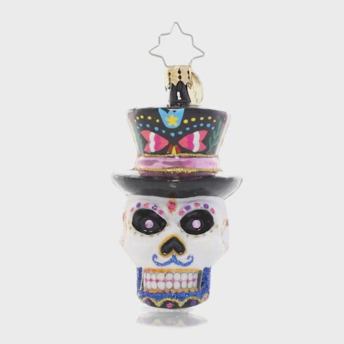 Video - Ornament Description - One Dapper Calavera Gem: This sugar skull ornament is truly head-turning! With a top hat, bold colors and intricate detailing, this calavera looks ready for his big night. This video shows the ornament spinning slowly. 