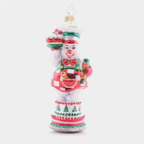 Video - Ornament Description - Cutie Pie Baker: This darling snow pal is the greatest cake maker. She uses cool icicle frosting so these baked goods are never defrosting. Join in the feast of this delicious sweet treat! The ornament spins slowly in the video.