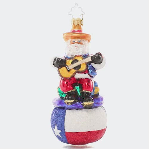 Video - Ornament Description - Pride of Texas Santa: Ho-ho-Howdy Partner! Santa shows his love for the state of Texas, donning his cowboy best and plucking along on his guitar atop a Texas-sized sack of gifts especially for all the good boys & girls in the Lonestar State! This video shows the ornament spinning slowly. 