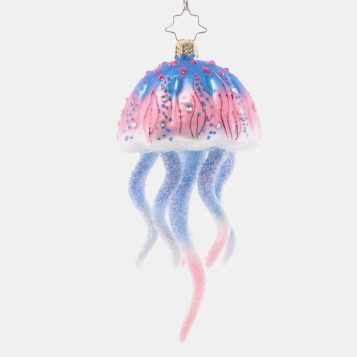 Video - Ornament Description - Colorful Jelly: This joyful jellyfish is a jubilee of pink and blue hues. Let this stunning sea creature float among the boughs of the tree, bringing nautical cheer for all to see!