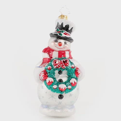Video - Ornament Description - Darling Christmas Decorator: Deck the halls! Wreath in hand, this sweet snowman is always first to volunteer for holiday decorating duty. The video shows the ornament slowly spinning. 