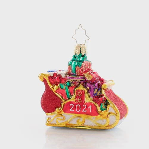 Video - Ornament Description - Precious Cargo 2021 Gem: Ready for takeoff! He has made his list and checked it twice--now the elves have packed up Santa's miniature sleigh in preparation for the biggest night of the year! This video shows the ornament spinning slowly. 