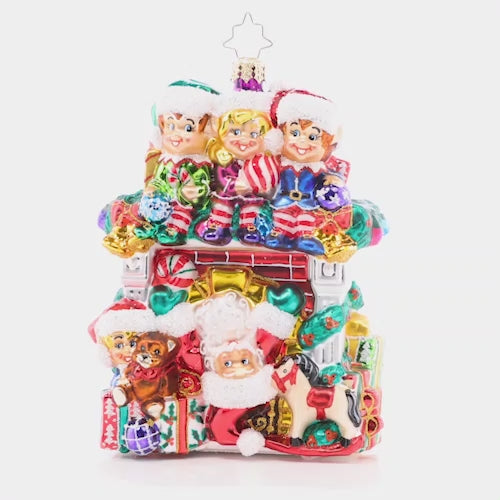 Video - Ornament Description - Fireplace High Jinks: Santa has all hands on deck this year – with a team of Christmas elves ready to help him spread cheer! This cozy fireplace is bedecked with gifts galore, making an adorable addition to your collection. This video shows the ornament slowly spinning. 