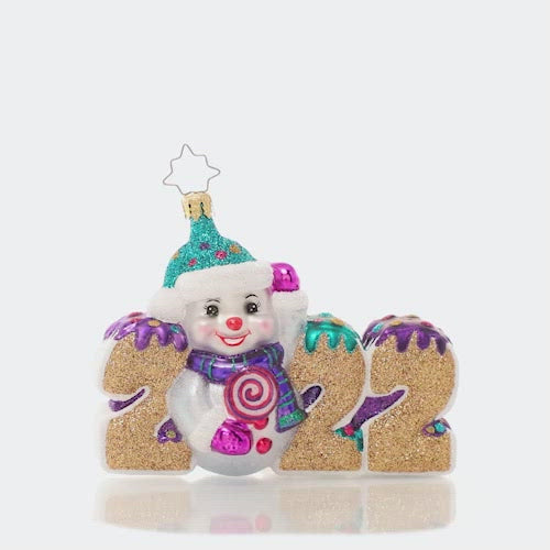 Ornaments - Description: Celebrate 2022 with this jolly ornament featuring a snowman and his candy stash. Here's hoping the year is a tasty treat for us all!