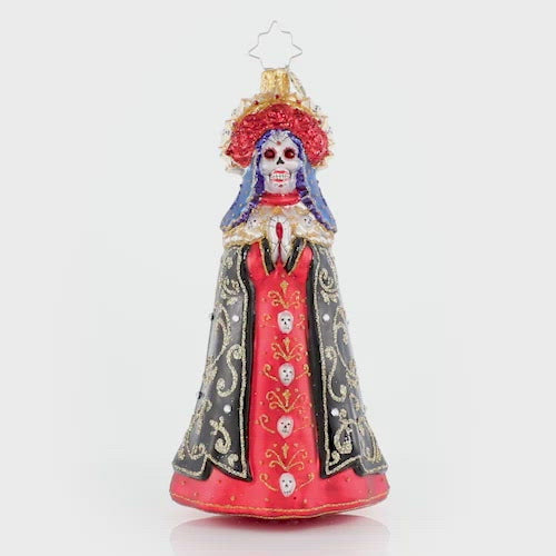 Video - Ornament Description - Lady of Shadows: Diosa mia! Crowned with a gilded flower halo and traditional threads of gold, La Catrina arrives to pay tribute at the altar. This video shows the ornament slowly spinning. 