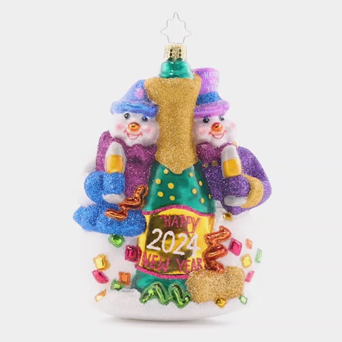 Video - Ornament Description - New Year's Toast: Two festive snow-friends are ringing in the new year with a big bottle of bubbly! Commemorate another wonderful year with this cute, cozy ornament. This video shows the ornament spinning slowly. 