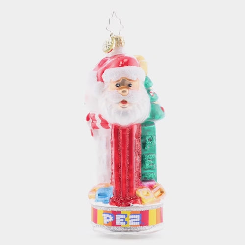 Video - Ornament Description - Jolly PEZ™: Bring iconic cheer to your holiday décor with this festive display of PEZ™ Candy dispensers. Three PEZ™ dispensers of Tannenbaum, Snowman and Santa Claus characters all atop the colorful trademark candy wrapper base. This video shows the ornament slowly spinning. 