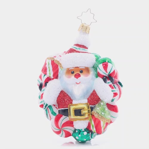 Video - Ornament Description - Peppermint Dreams Santa: This darling Santa is surrounded by a wreath of delicious peppermints. Decorate your tree with this candy-coated red and green treat! This video shows the ornament spinning slowly. 