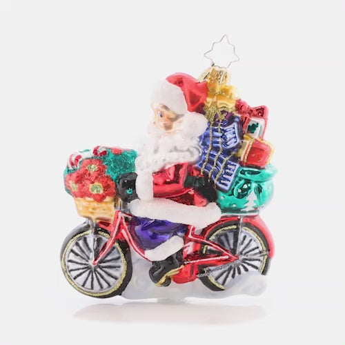Video - Ornament Description - Santa's Ride Around Town: Cruising down the boulevard on his 10-speed, Santa is delivering perfectly-packed presents in eco-friendly style. Celebrate the cyclists in your life with this whimsical ornament! This video shows the ornament slowly spinning. 